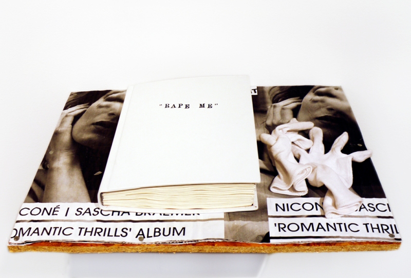 Installation view, "Rape Me", 2010, calf-leather hand-bound artist book: pen, pencil, texta, crayon on 300 pages (drawn on the published diaries of Kurt Cobain), 28 x 22 x 6cm, unique piece, on shelf made from band posters