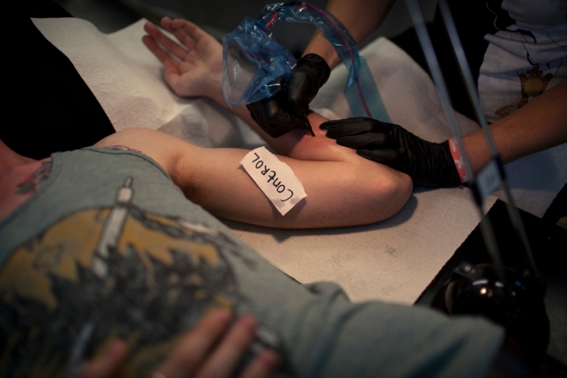 Stellmach tattooing a participant, The Letting Go, Berlin Festival, photo by Michael Lelliott